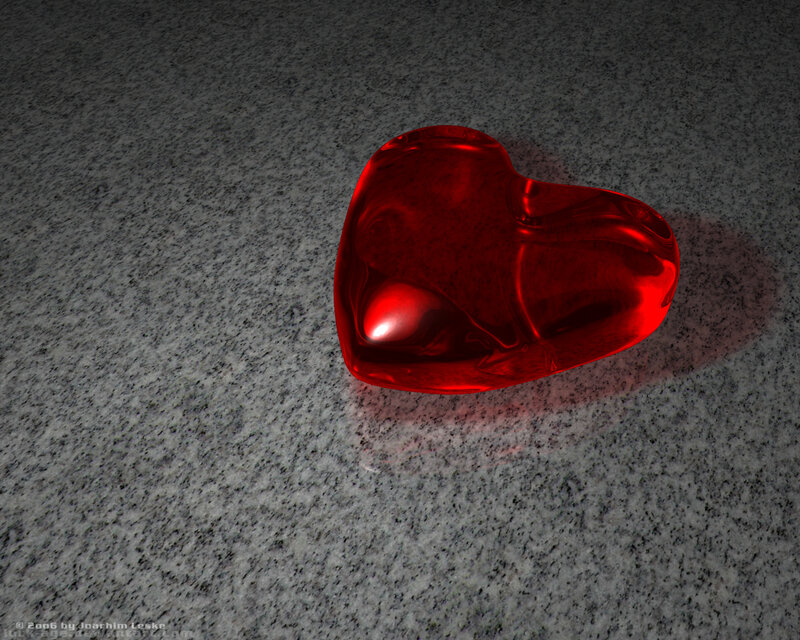 Red glass heart on stone