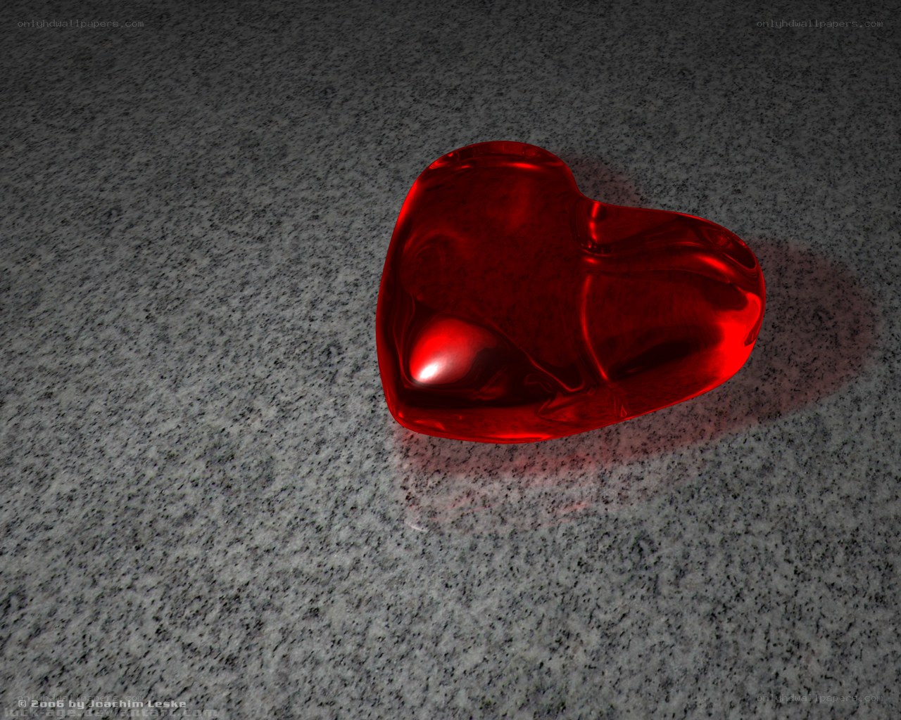 Red glass heart on stone