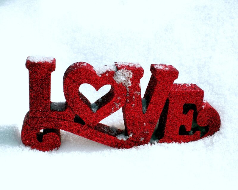 Red glitter love sign in snow