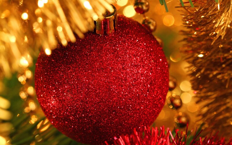 Red glitter ornament on tree