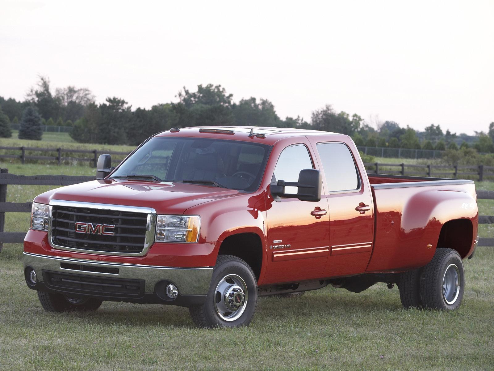 Red GMC pickup truck in field