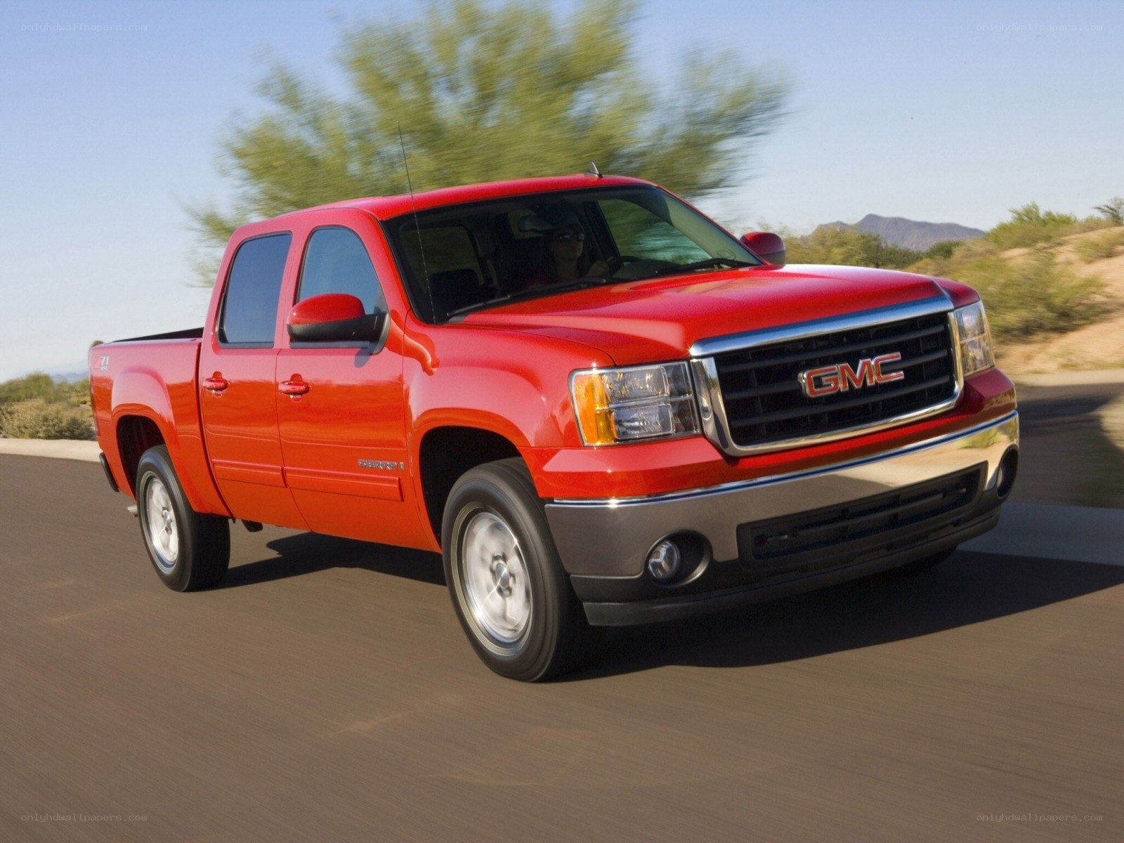 Red GMC Sierra in motion