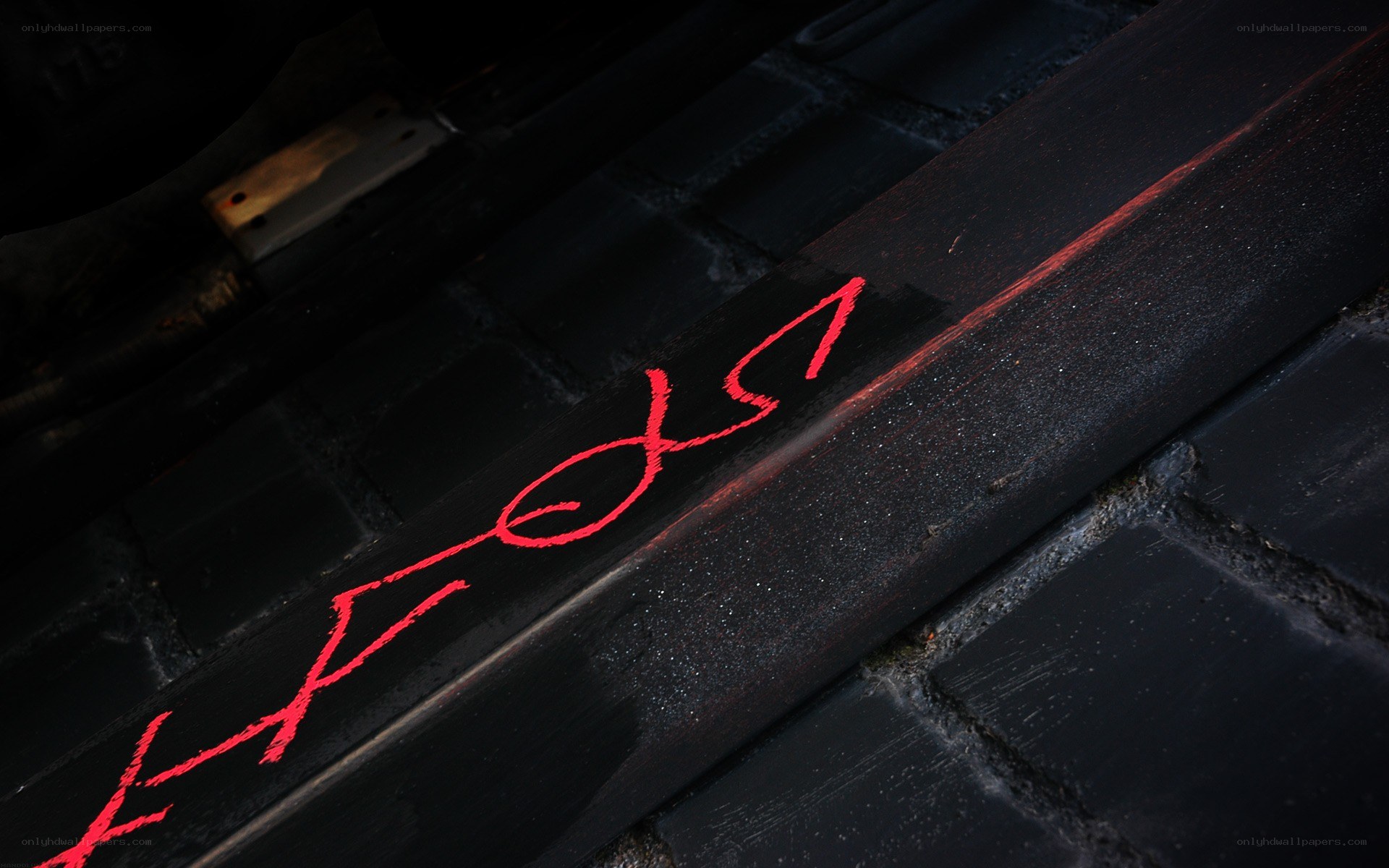 Red graffiti on black surface