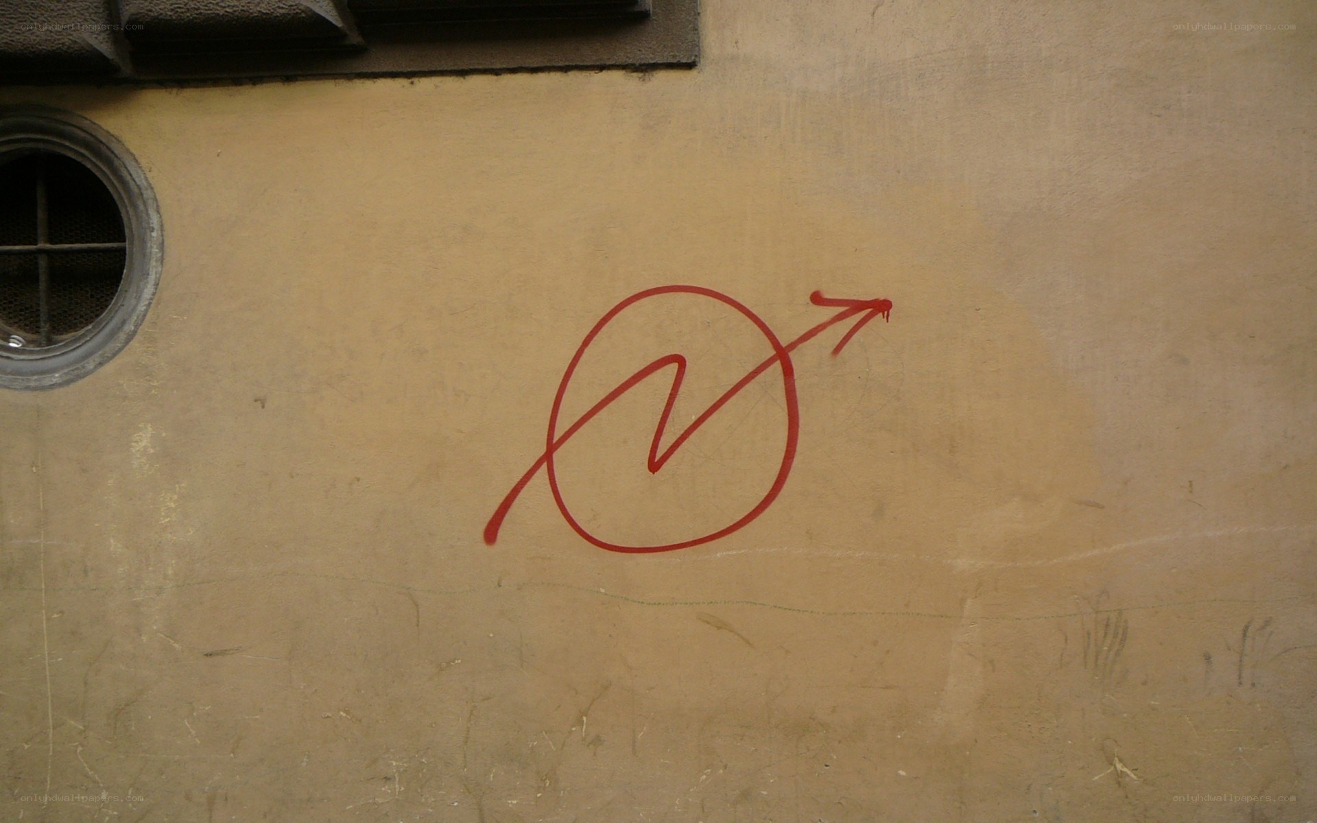 red graffiti symbol on wall
