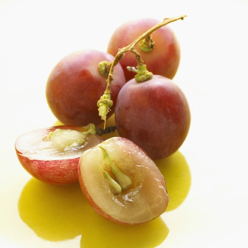 Red grapes on a white surface