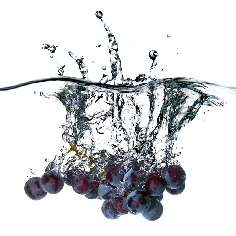 Red Grapes Splashing in Water