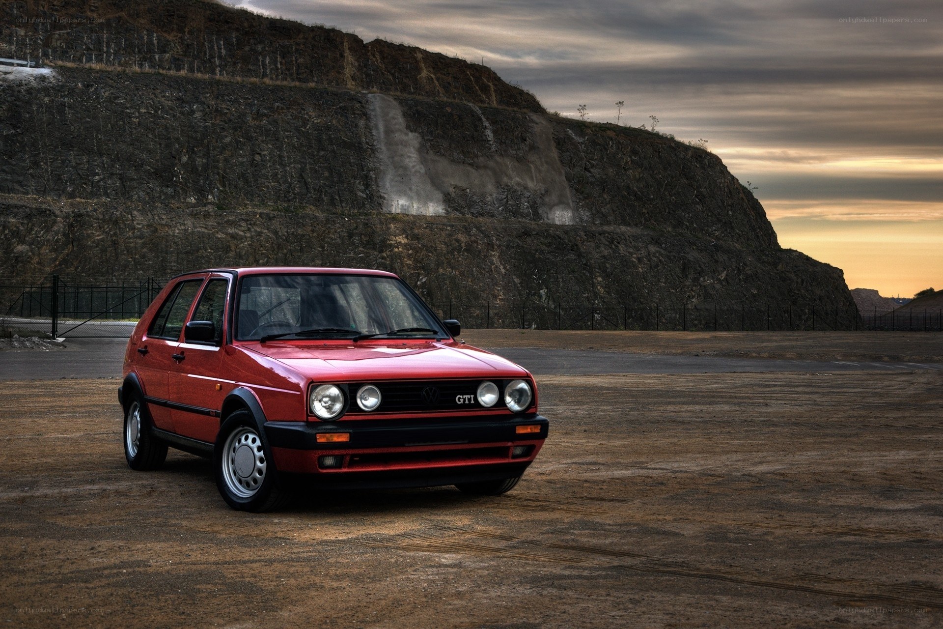 Red GTI in quarry at sunset