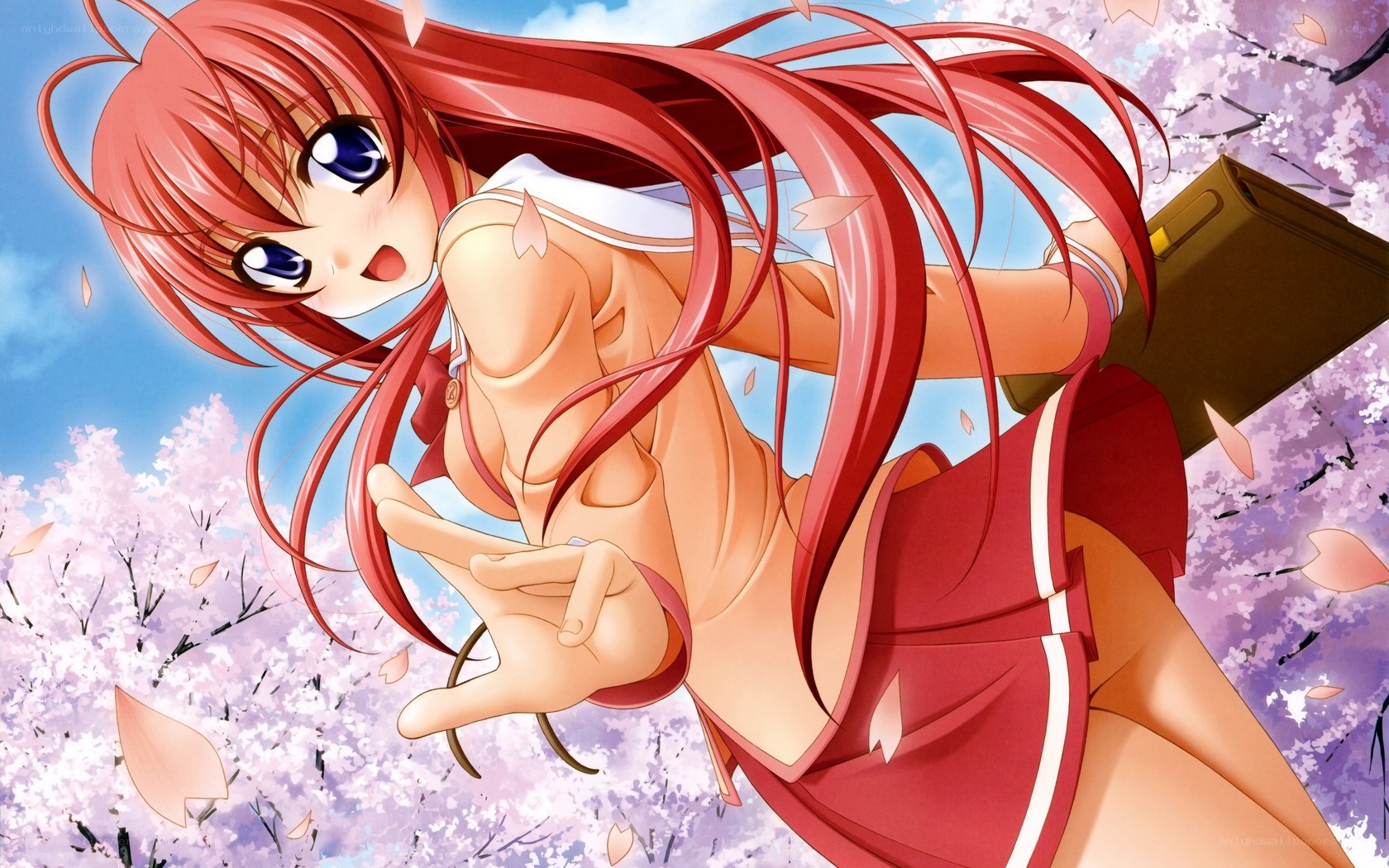 Red-haired girl in cherry blossoms