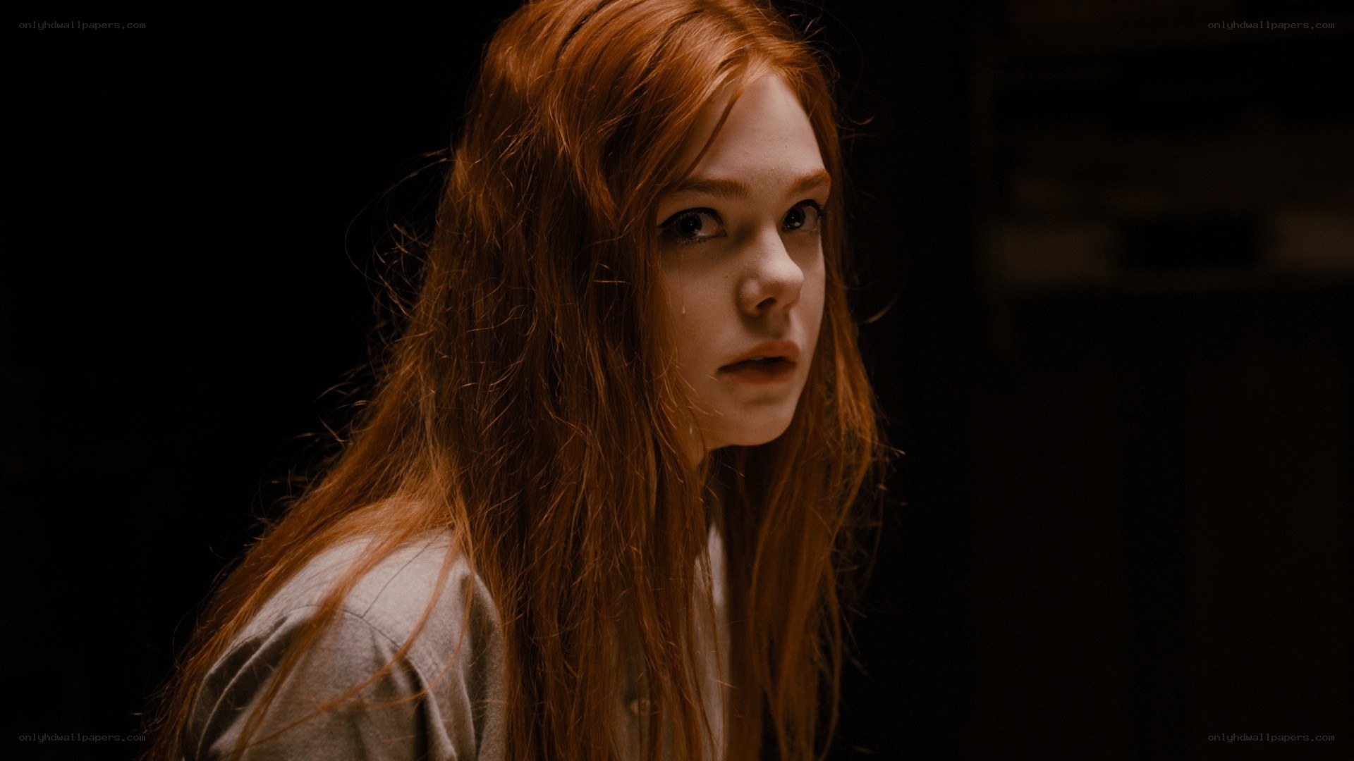 red-haired girl in dim light