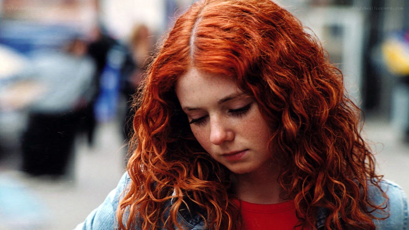 red-haired girl looking down
