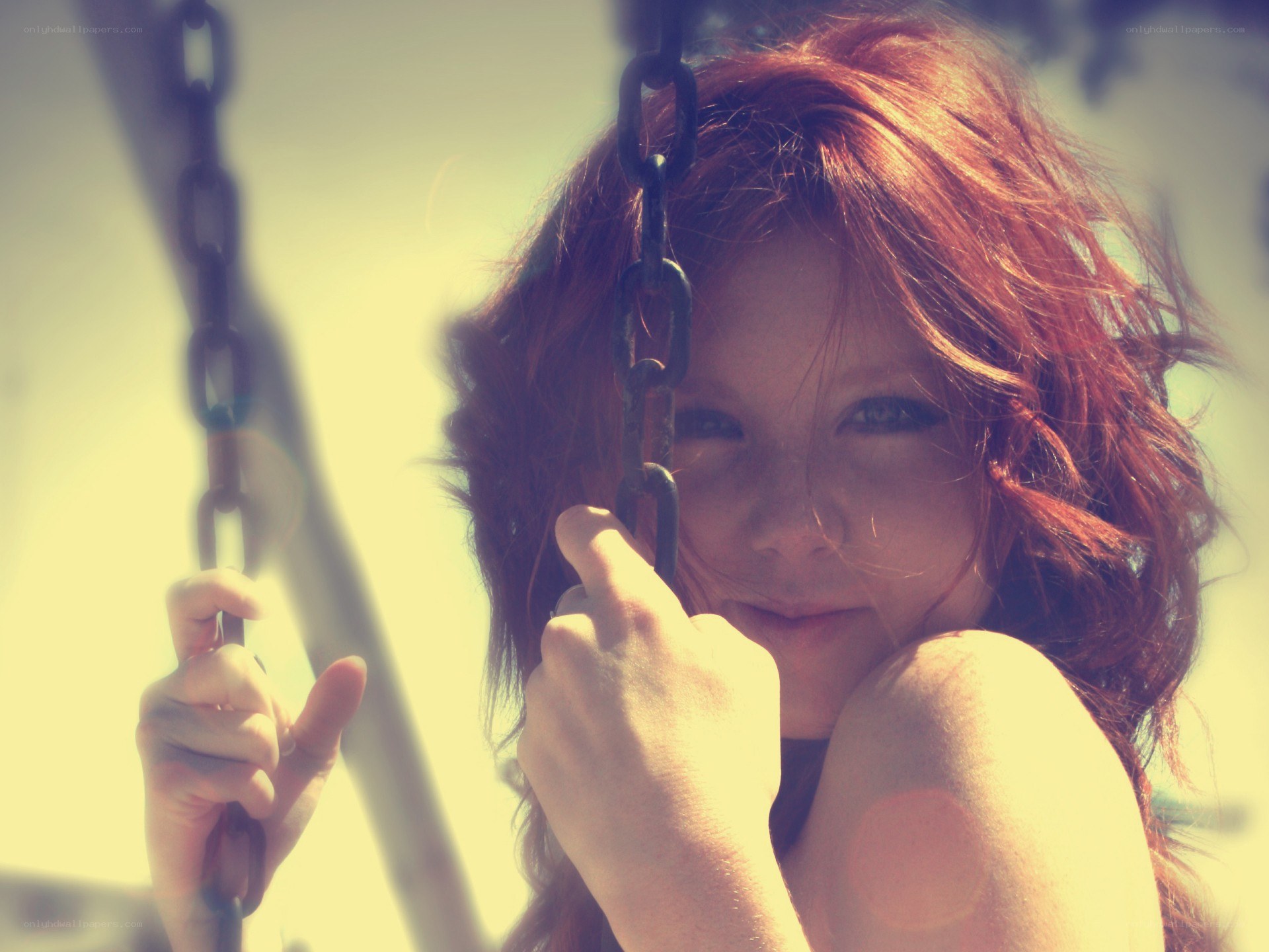 Red-haired girl on a swing