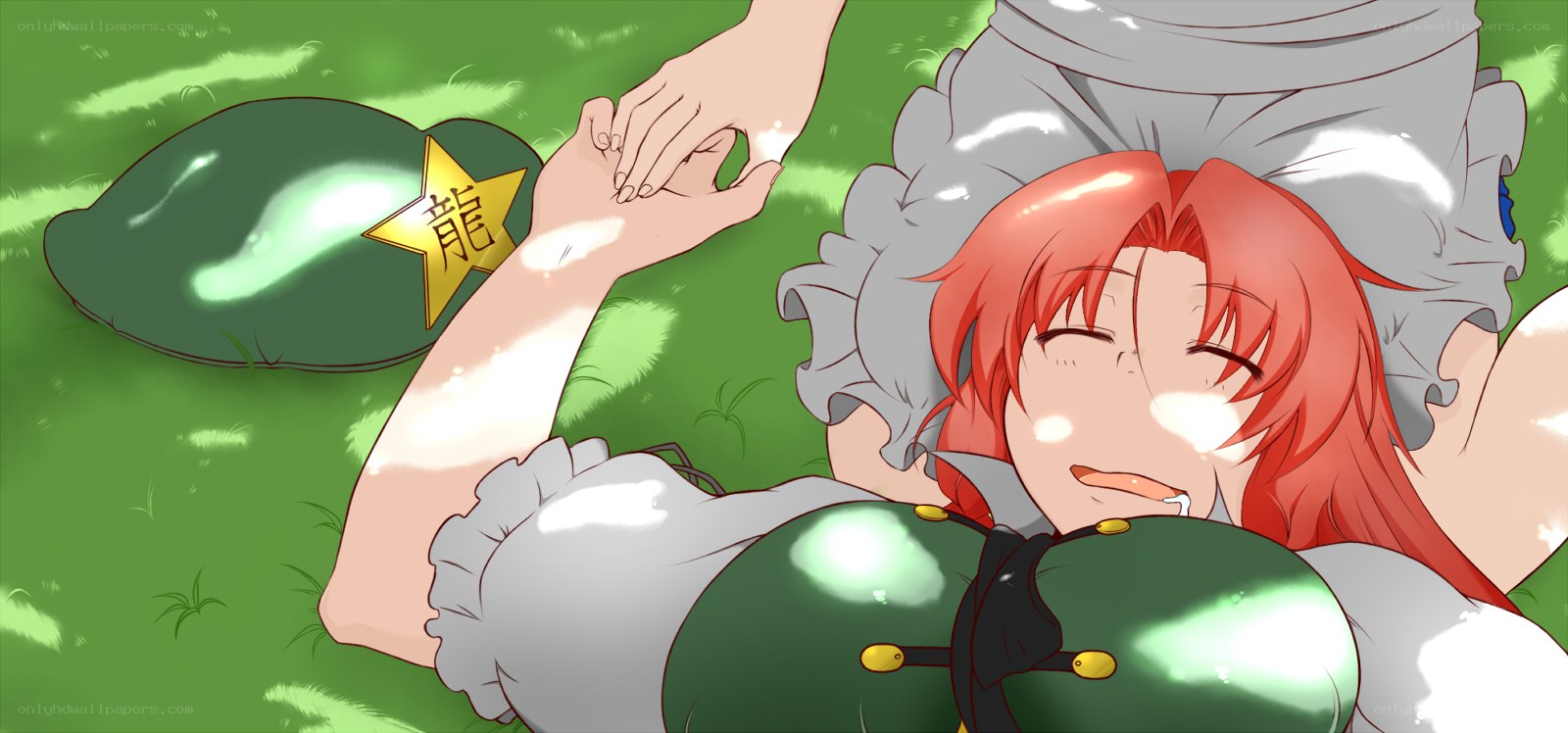 Red-haired girl resting on grass