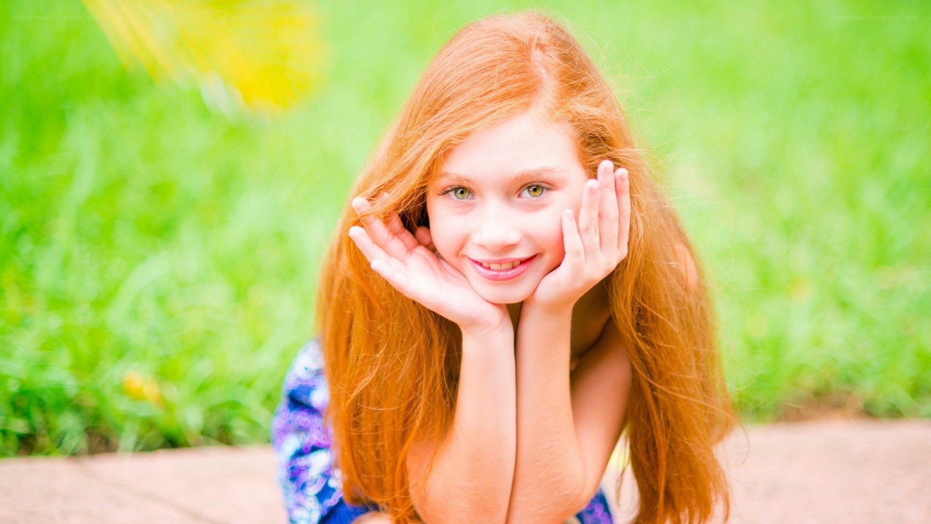 red-haired girl smiling outdoors