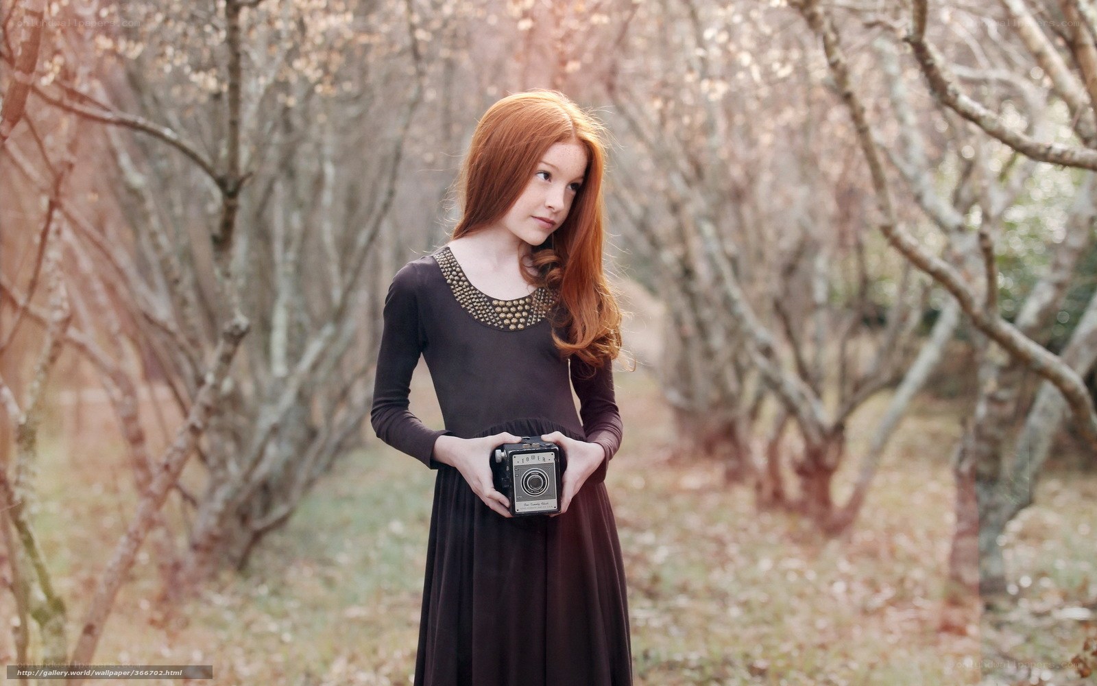 Red-haired girl with vintage camera