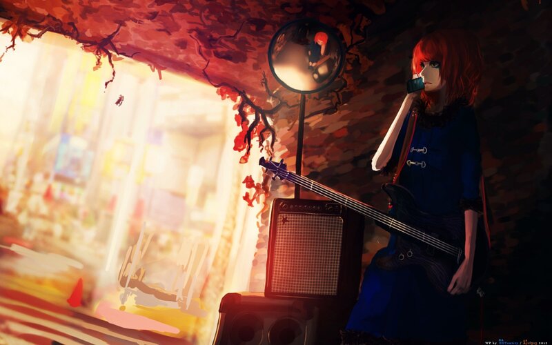 Red-haired musician with bass guitar