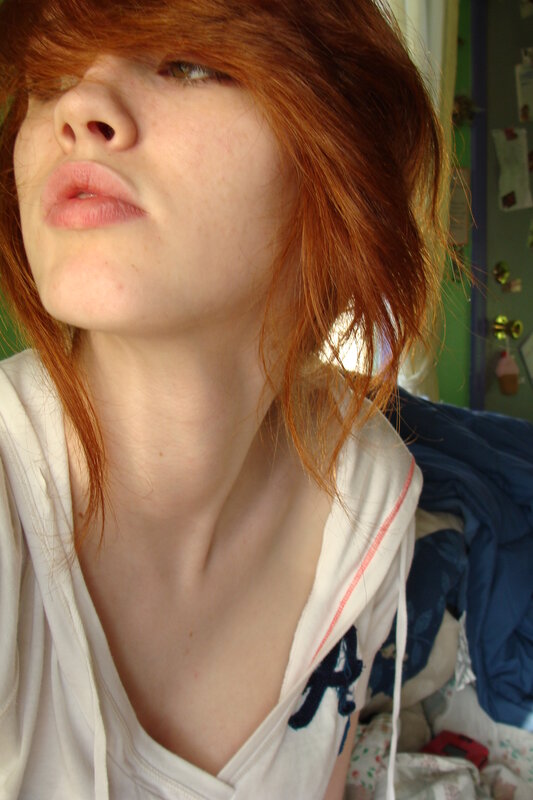 red-haired person in white hoodie