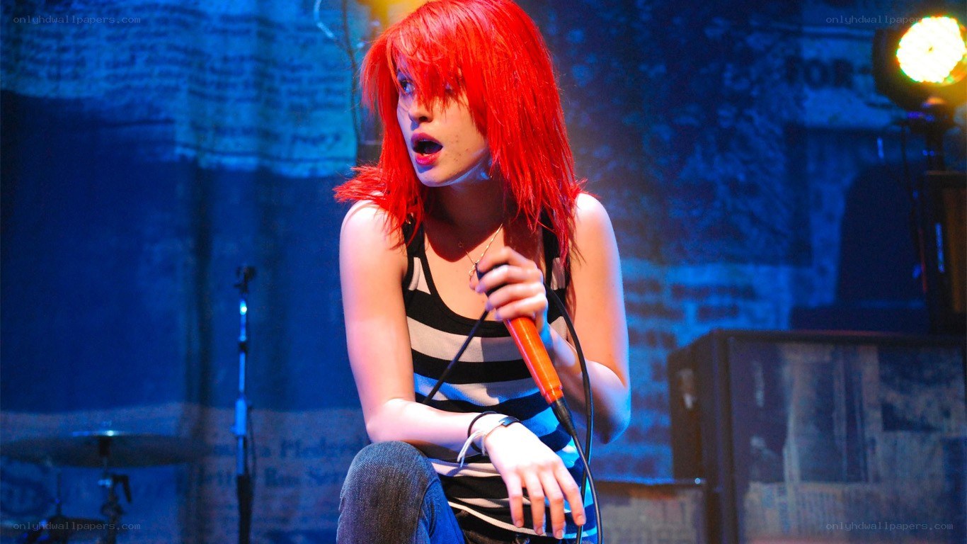 Red-haired singer performing on stage