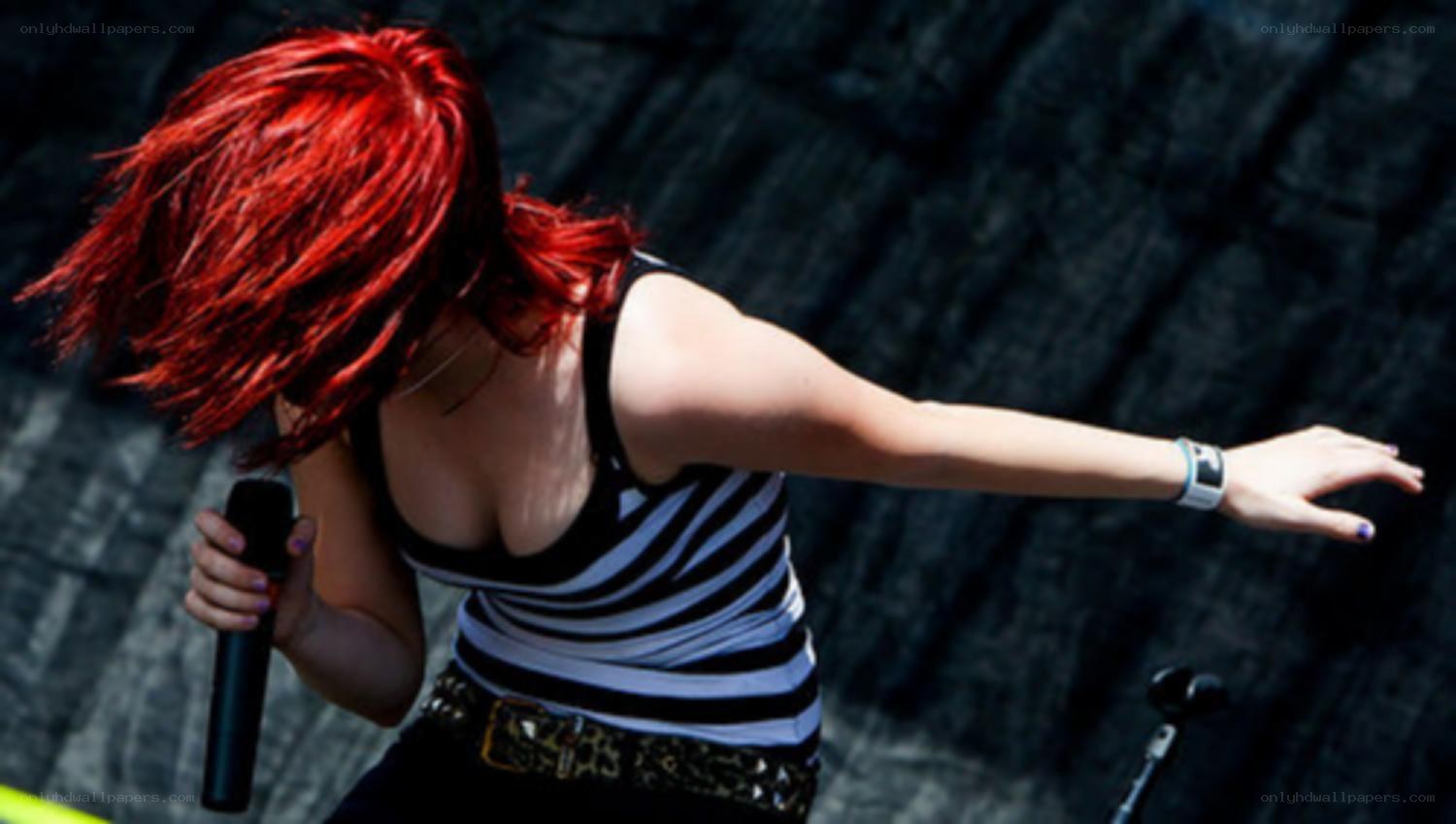Red-haired singer performing on stage