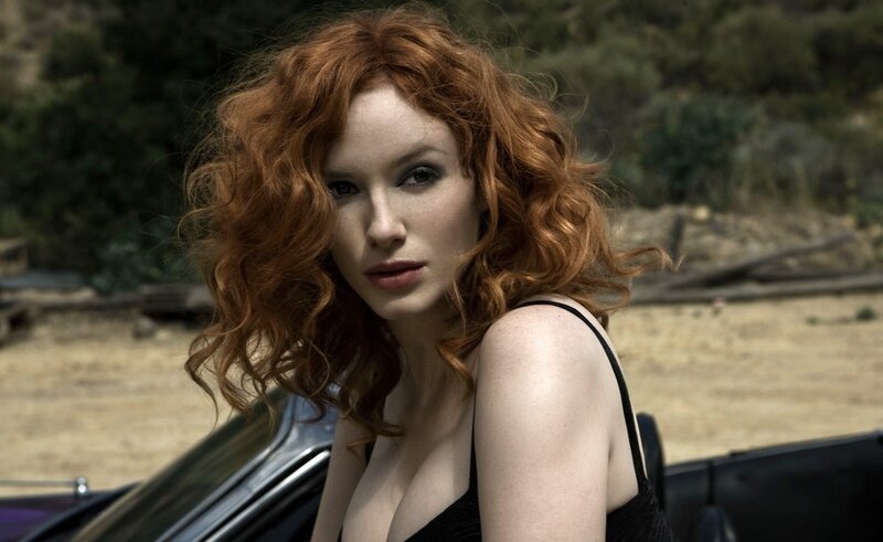 Red-haired woman by car