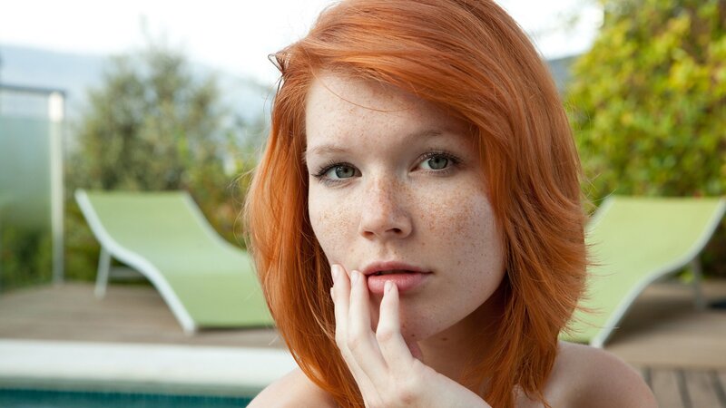 Red-haired woman by pool
