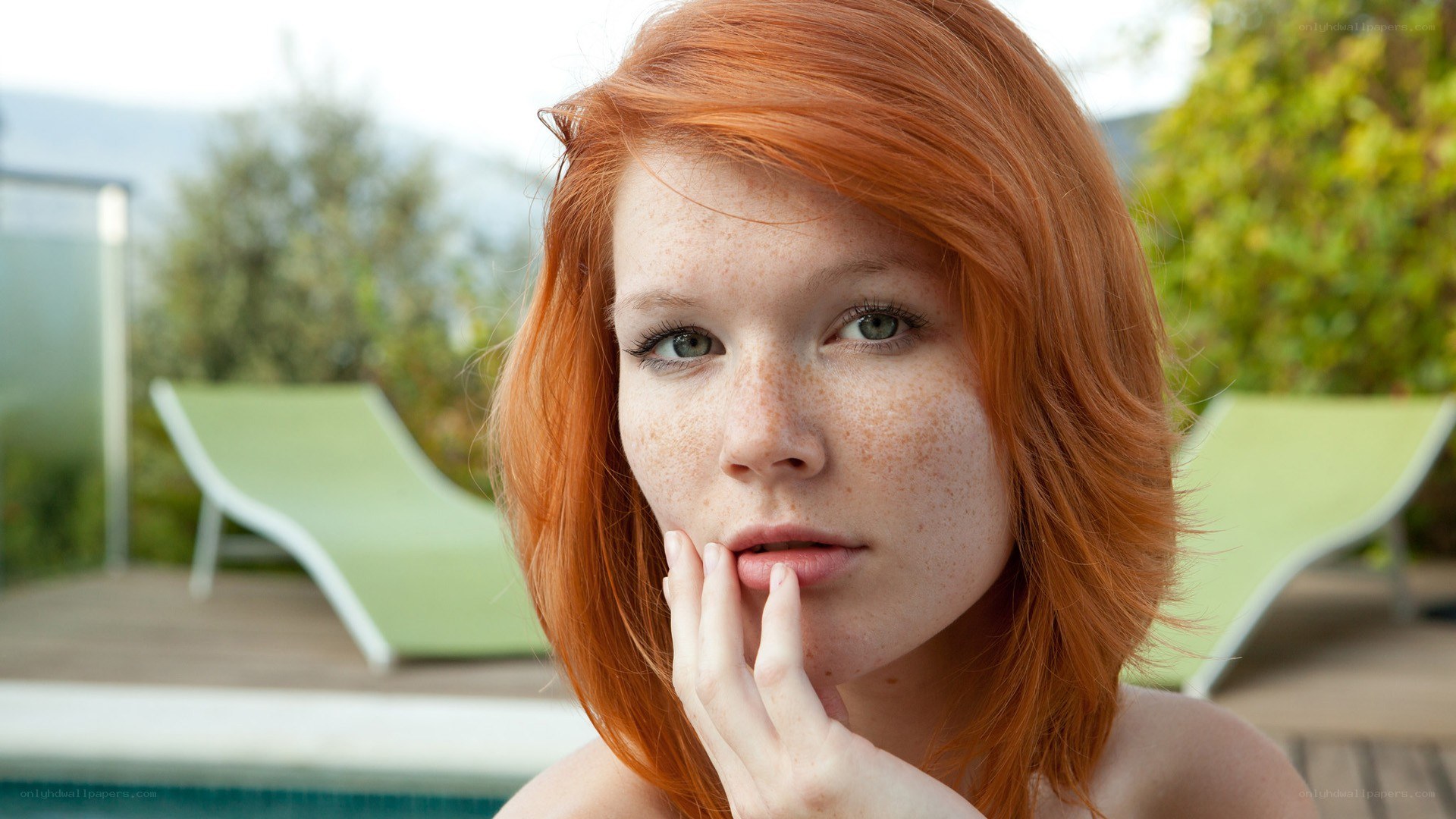Red-haired woman by pool