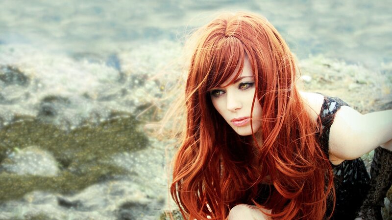 Red-haired woman by the water