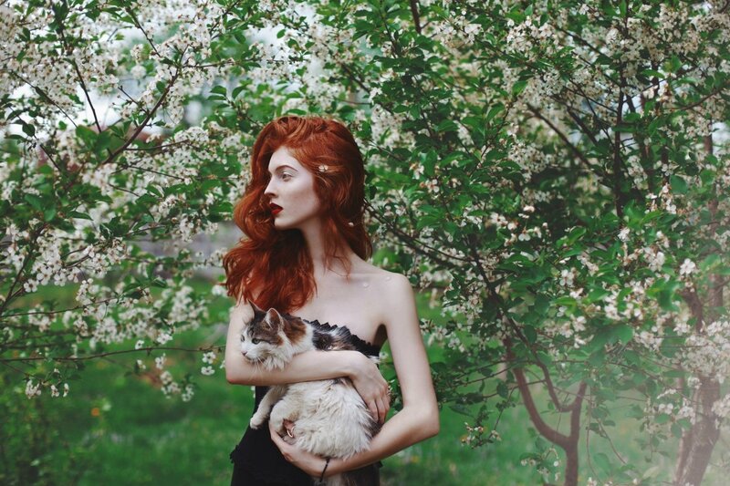 Red-haired Woman Holding Cat