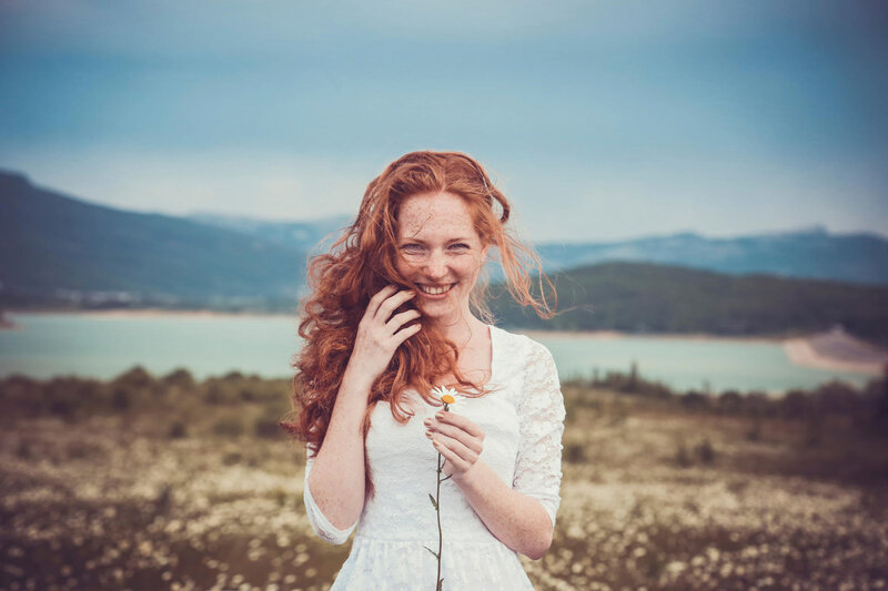 Red-haired Woman Holding Flower