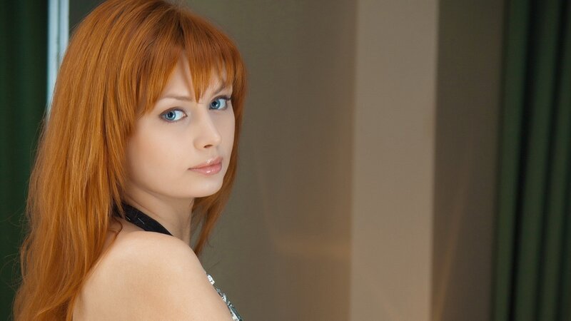 Red-haired woman in a black top