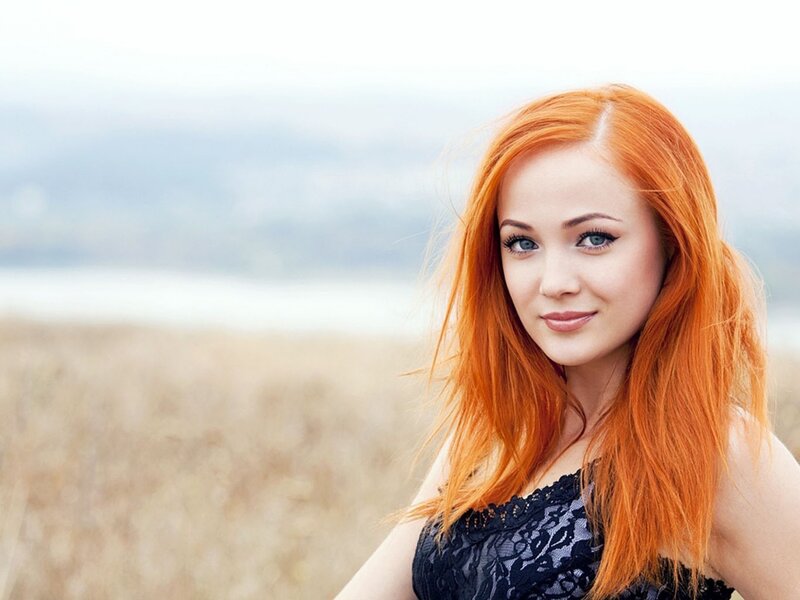 Red-haired woman in a field