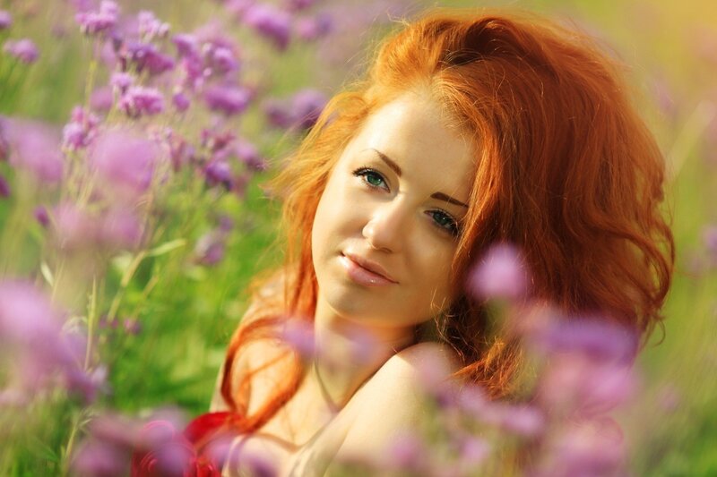 Red-haired woman in a flower field