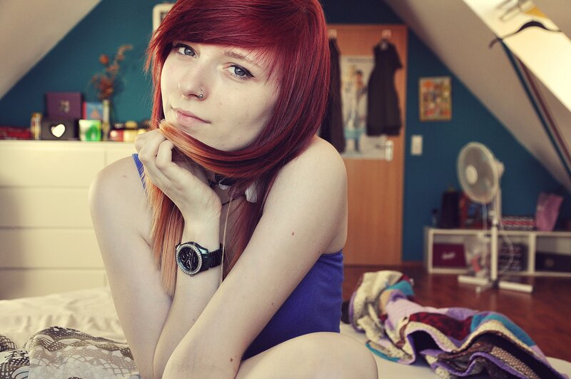 Red-haired woman in bedroom