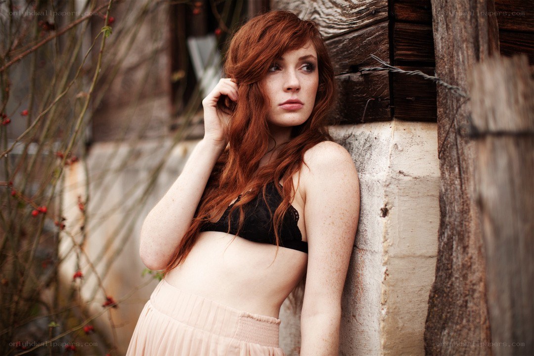 Red-haired woman in black bra