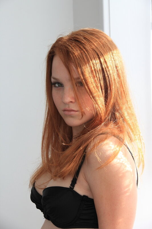 red-haired woman in black top