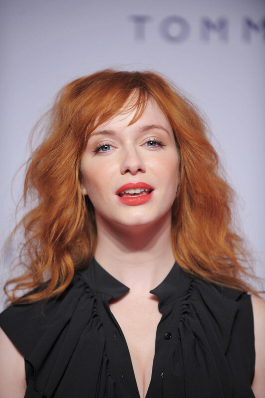 red-haired woman in black top