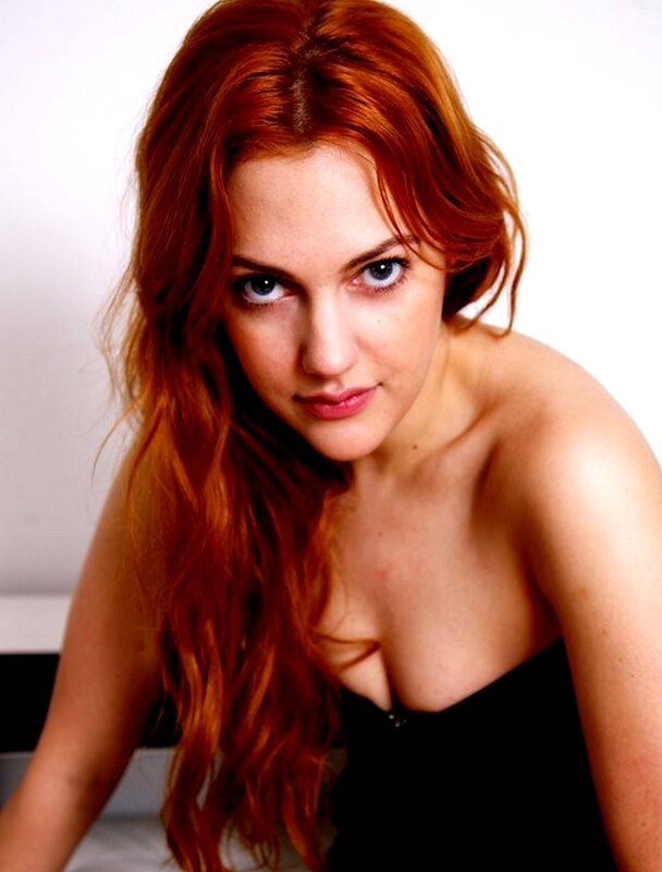 Red-haired woman in black top