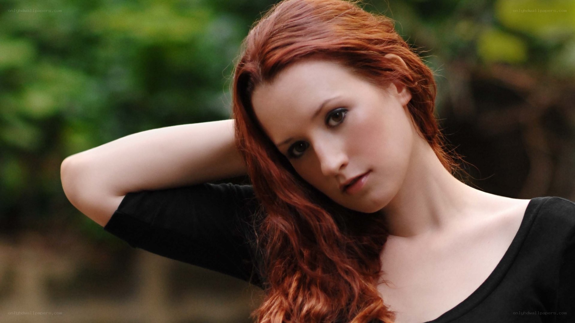 red-haired woman in black top