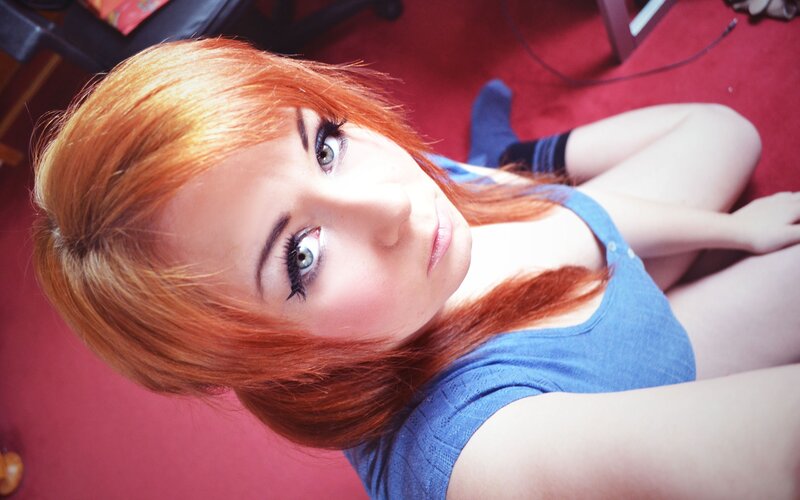 red-haired woman in blue top