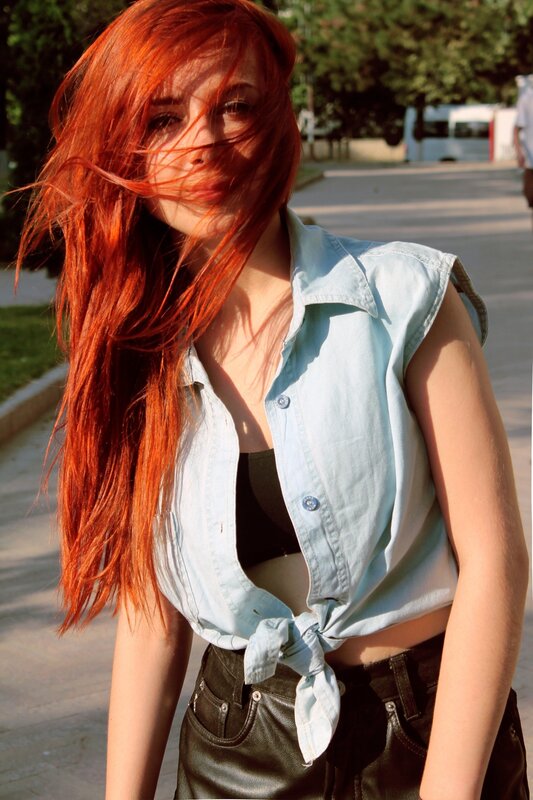 Red-haired woman in denim shirt