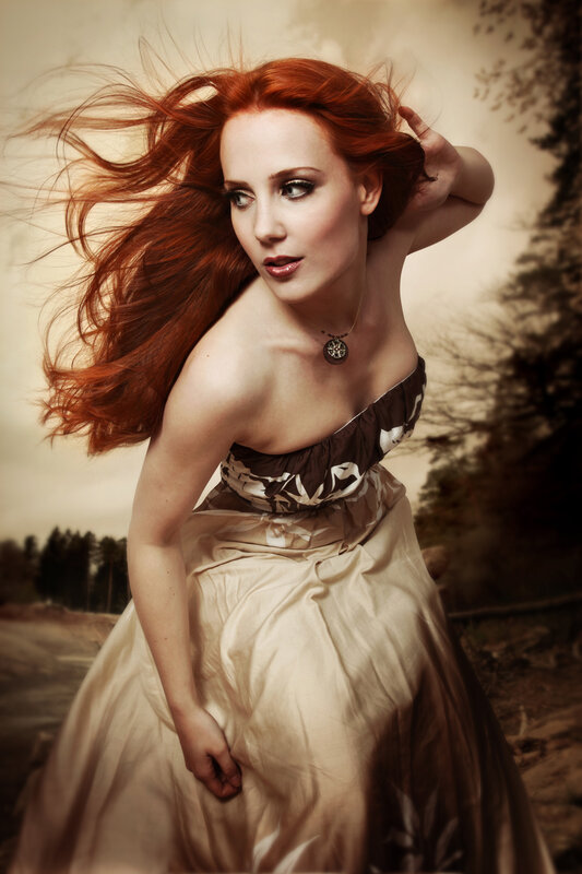Red-haired woman in flowing dress