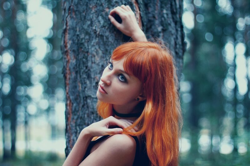 Red-haired woman in forest