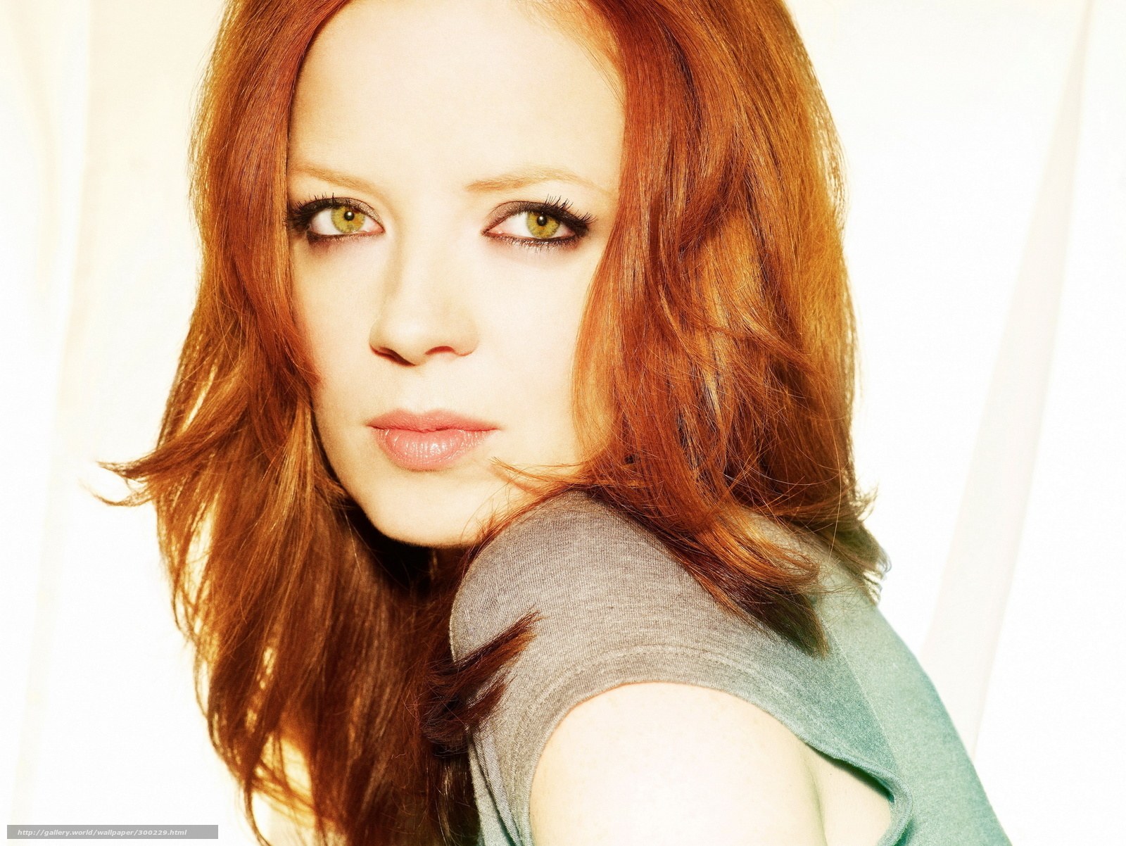 red-haired woman in gray top