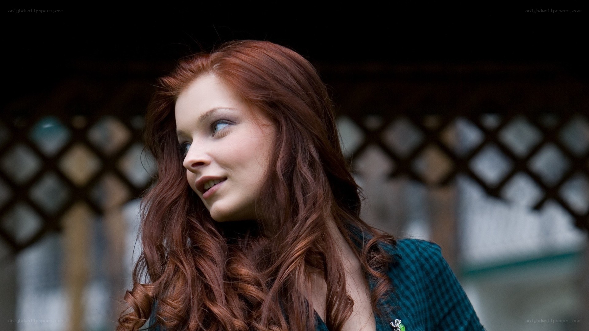 red-haired woman in green jacket