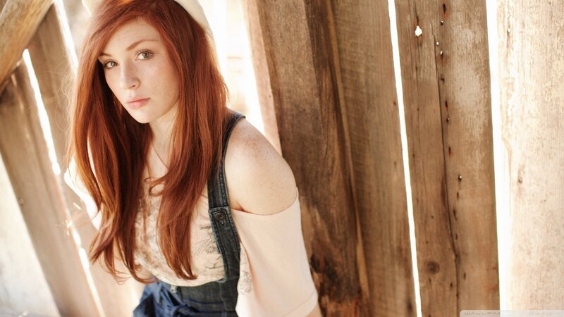 red-haired woman in overalls