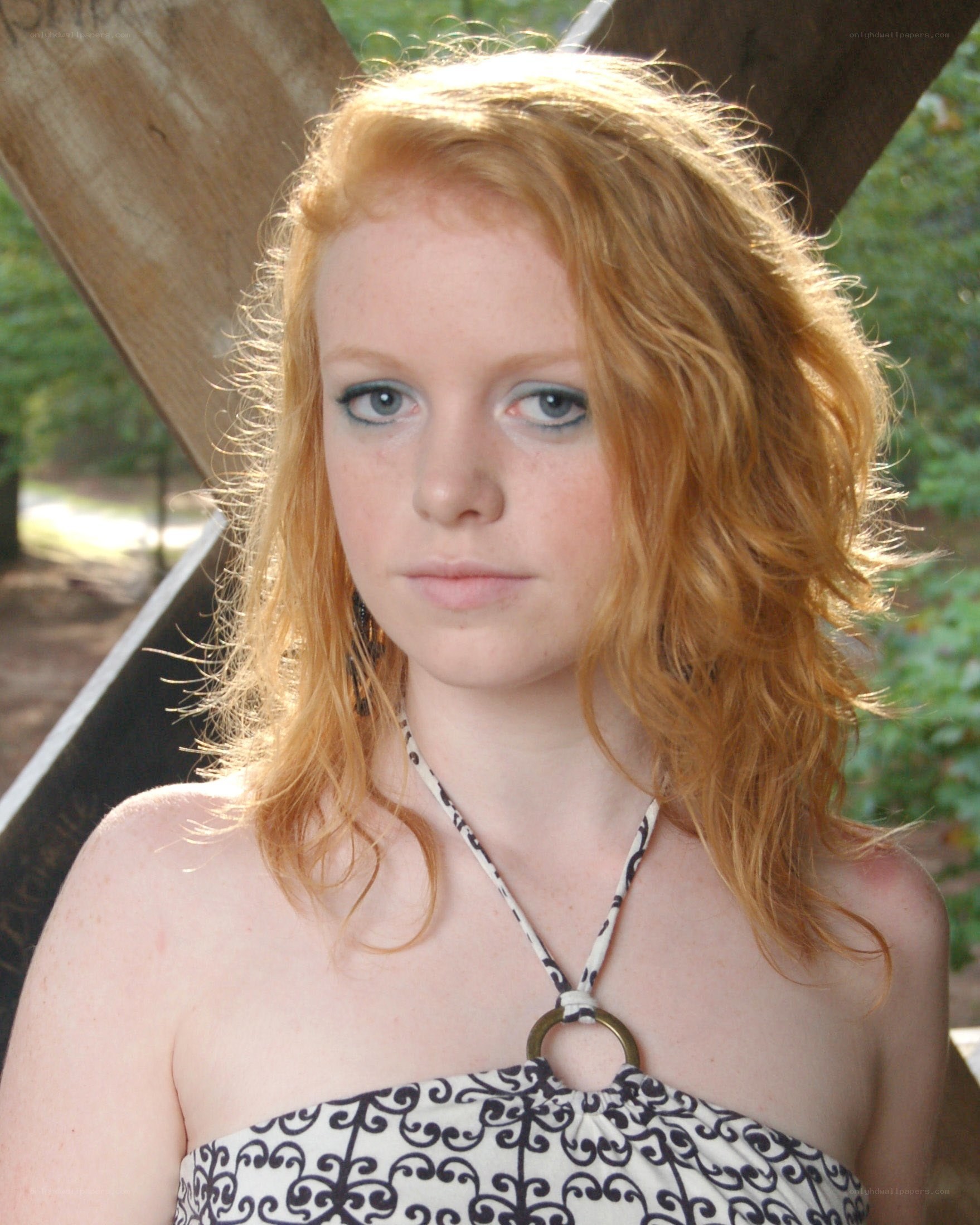 red-haired woman in patterned top