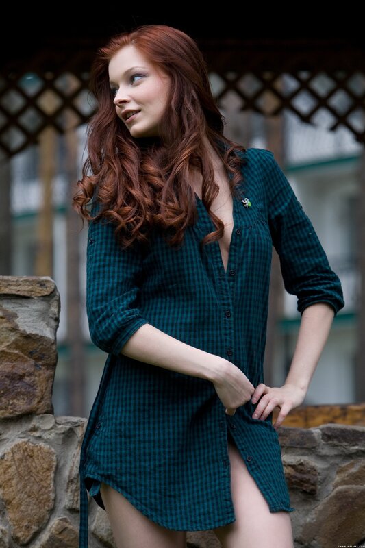 Red-haired woman in plaid shirt