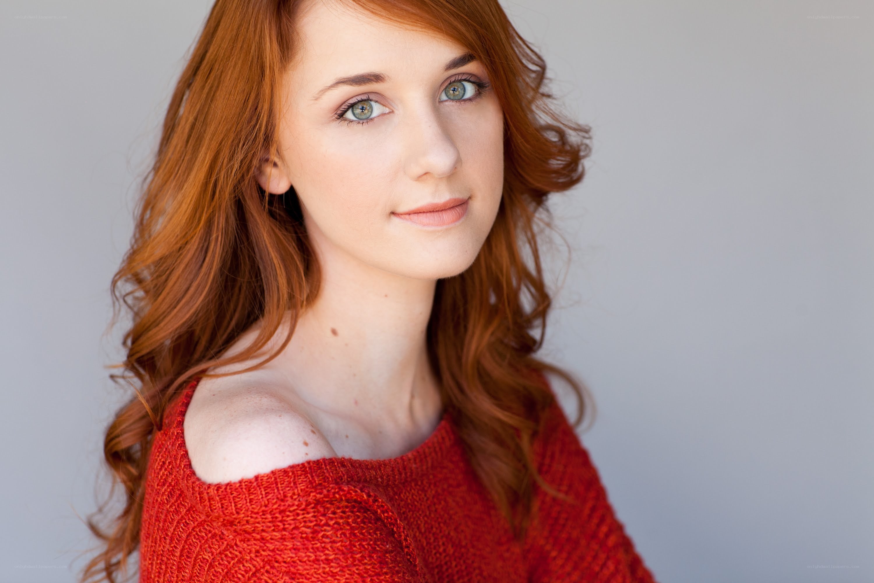 red-haired woman in red sweater
