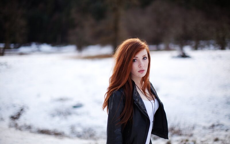 Red-haired woman in snowy field