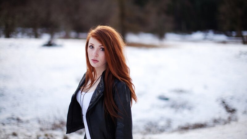 Red-haired woman in snowy field