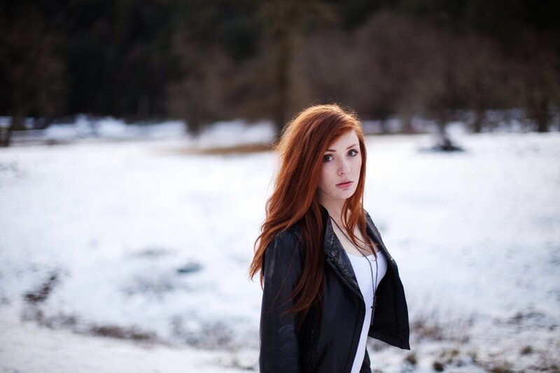 Red-haired woman in snowy field